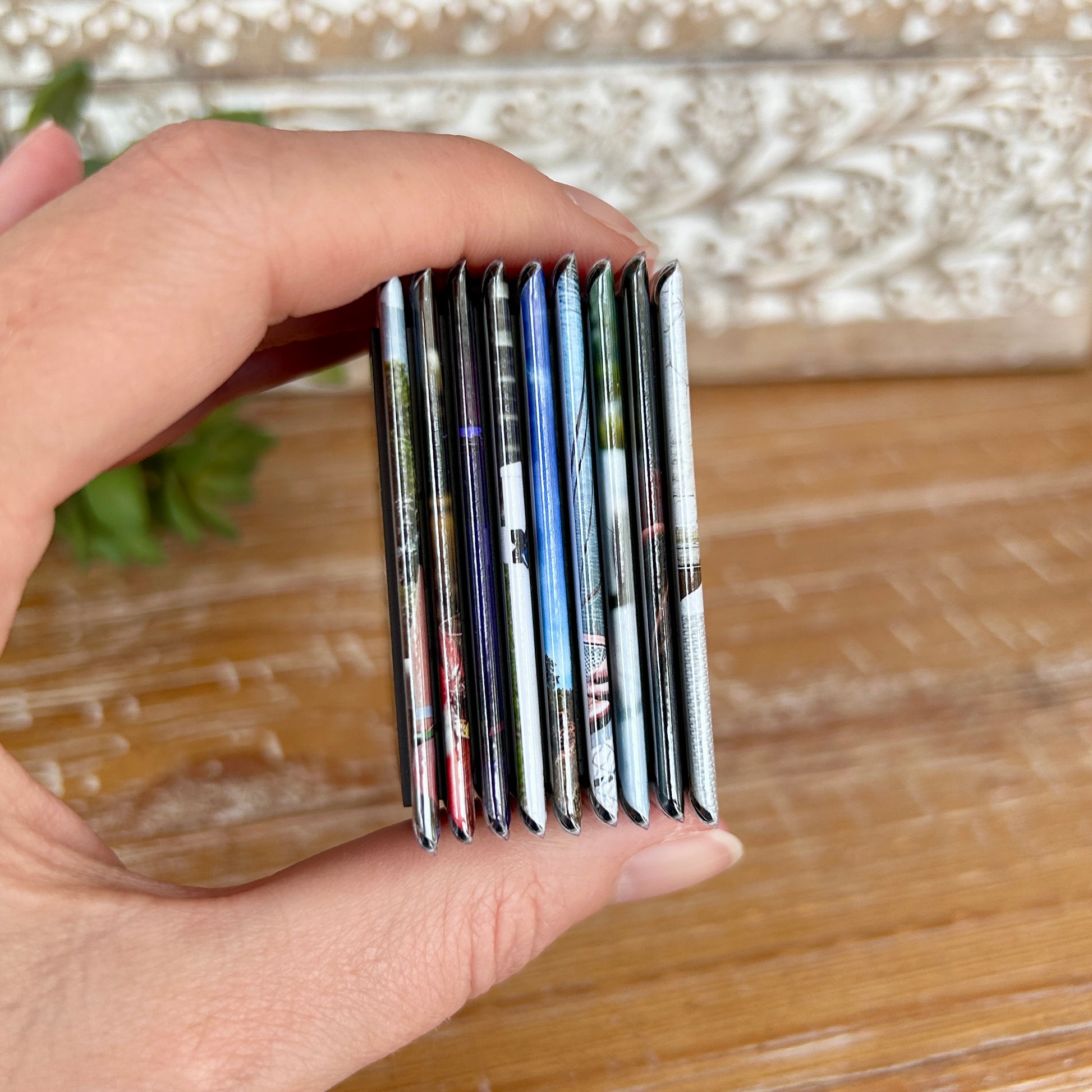 Side view of 9 two by two inch photo magnets