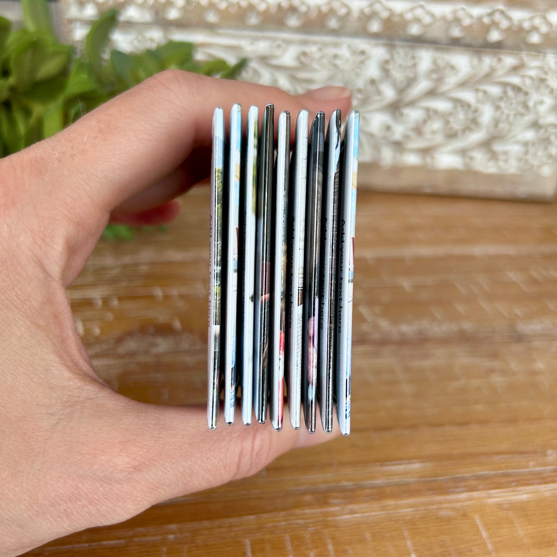 Side view of a stack of 9 large photo magnets.