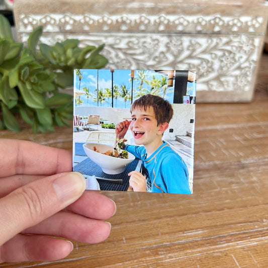 One 2.5 by 2.5 inch photo magnet with a smiling boy on it
