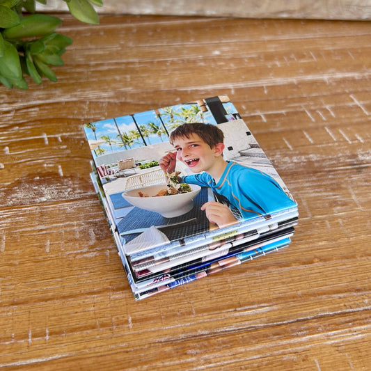 A stack of 9 photo magnets in the 2.5 x 2.5" size. The top magnet shows a smiling boy.